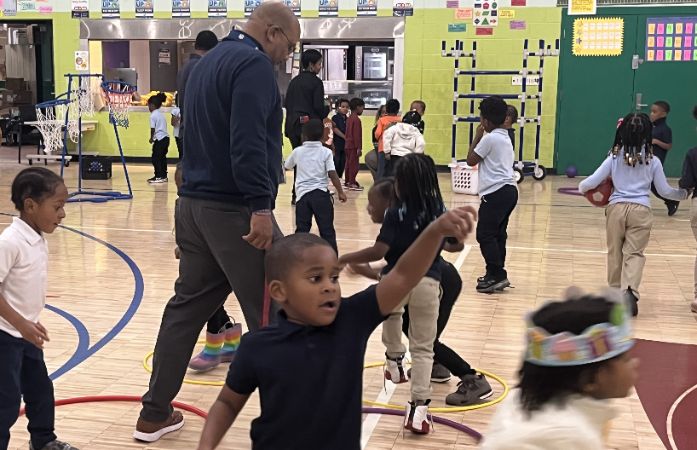 Principal and students playing with hoops